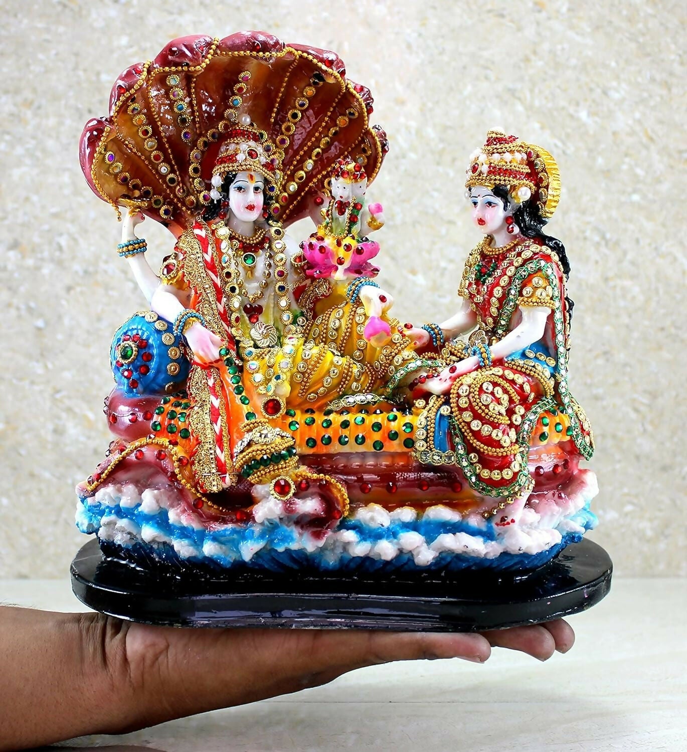Gold-colored Vishnu with Laxmi idol from the Esplanade collection, depicting gods in Ksheer Sagar, detailed and ornate.