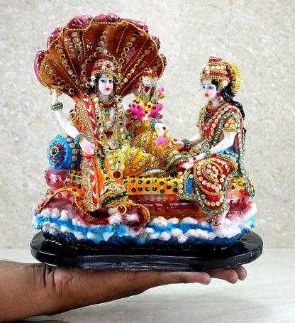 Gold-colored Vishnu with Laxmi idol from the Esplanade collection, depicting gods in Ksheer Sagar, detailed and ornate.