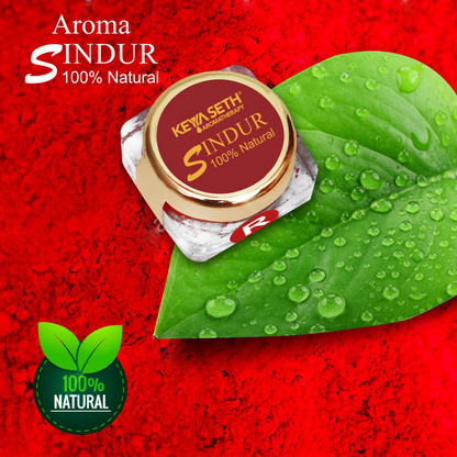Red Sindoor powder in a small container, natural makeup product by Keya Seth Aromatherapy used for traditional Indian ceremonies.