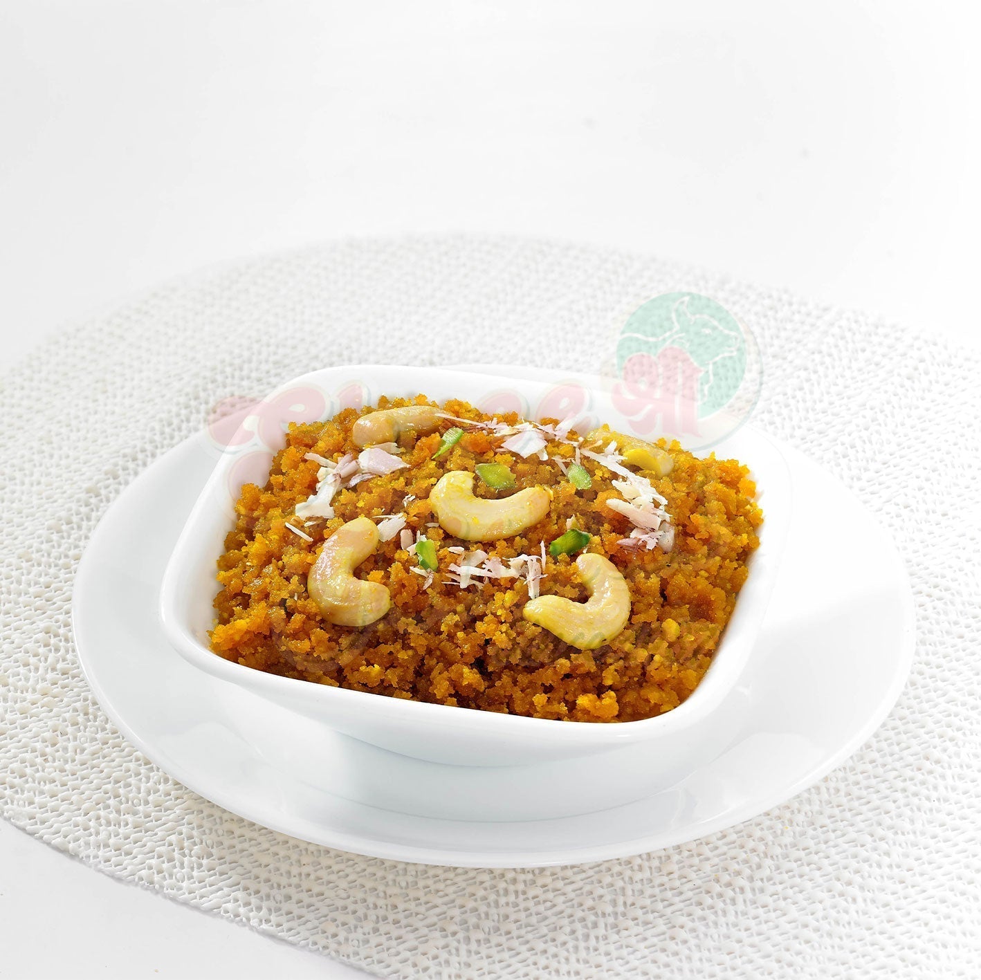 Shree Mithai Moong Dhal Halwa, a rich North Indian sweet with creamy yellow moong dal halwa garnished with nuts.