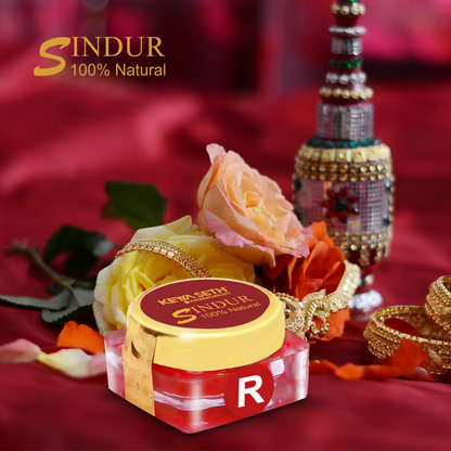 Red Sindoor powder in a container from Keya Seth Aromatherapy, used as traditional makeup for women.