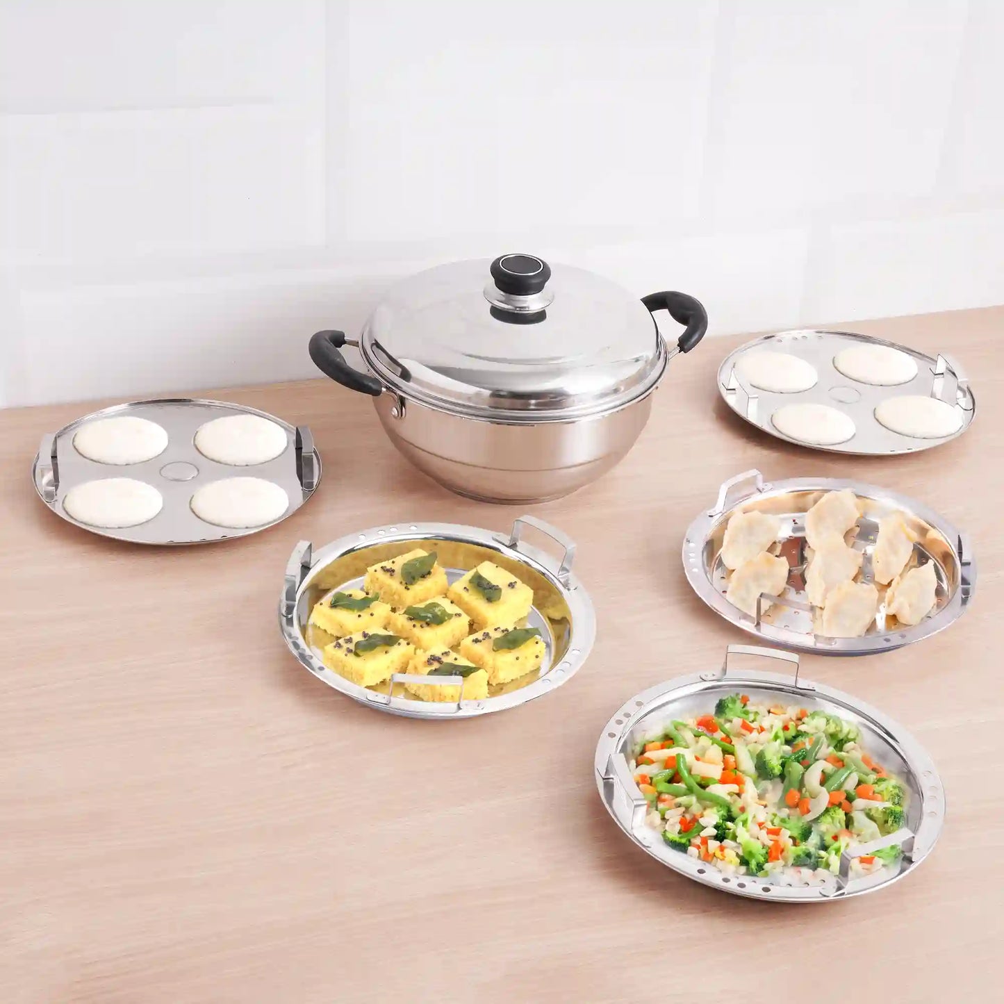 The Indus Valley 8 Pit Tri-Steel Multi Pot Handi with stainless steel plates for steaming idli, dhokla, and momos, tri-ply induction bottom.