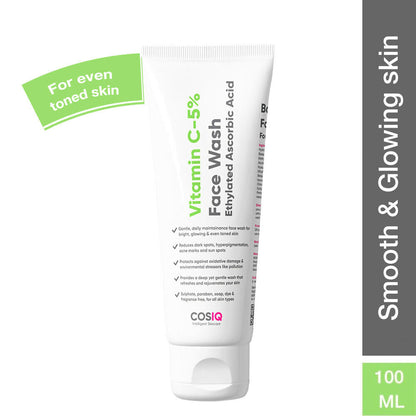 Cos-IQ Vitamin C-5% Brightening Face Wash showing a clear tube with orange-colored product and fresh citrus slices.