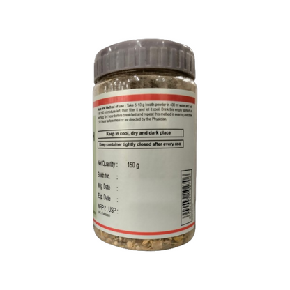 Patanjali Divya Immunogrit Kwath herbal ayurvedic herbal tea in a glass cup with fresh herbs and lemon slices.
