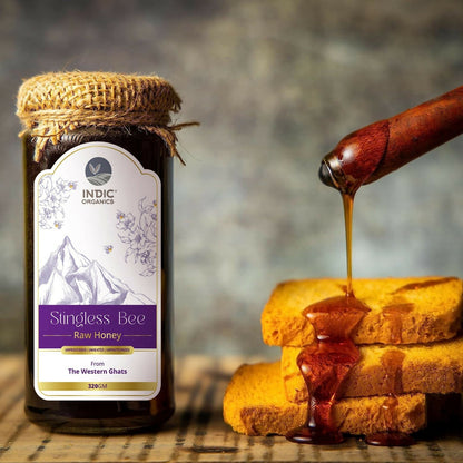 Small jar of Indic Organics stingless bee raw honey from Western Ghats, used as a natural spread or condiment.