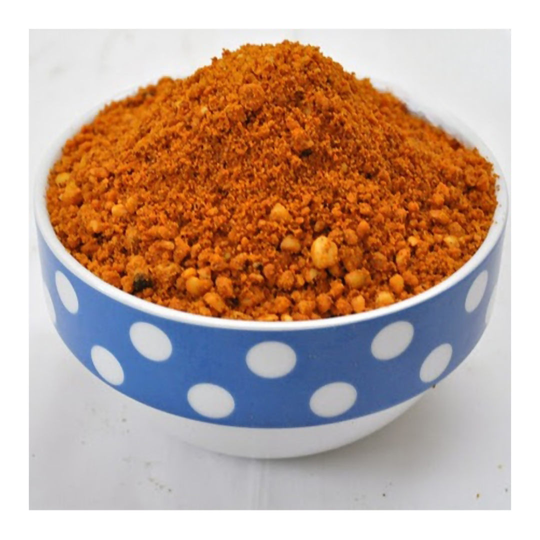 21Pickles Palli Podi chutney powder in a bowl, showcasing vibrant spices and texture for traditional South Indian flavor.