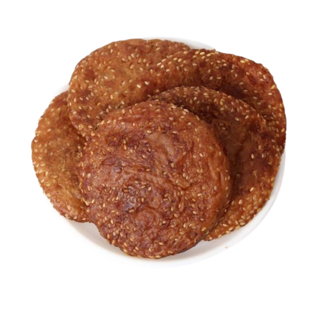 Gummadi Foods Nuvvula Ariselu Ghee, North Indian sweet made with sesame and jaggery, served on a traditional plate.