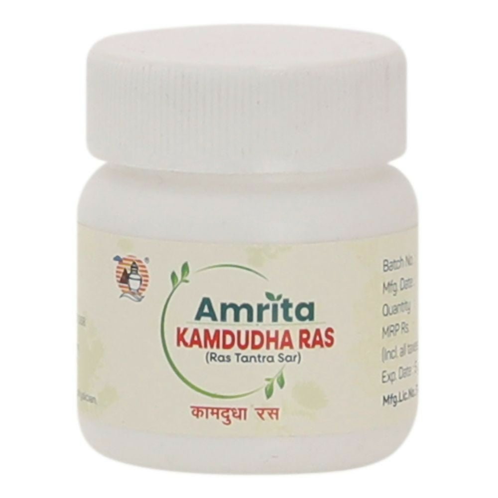 Amrita Kamdudha Ras Ayurvedic tablets in a glass jar, showing traditional herbal tablets used for balancing stomach and digestion.