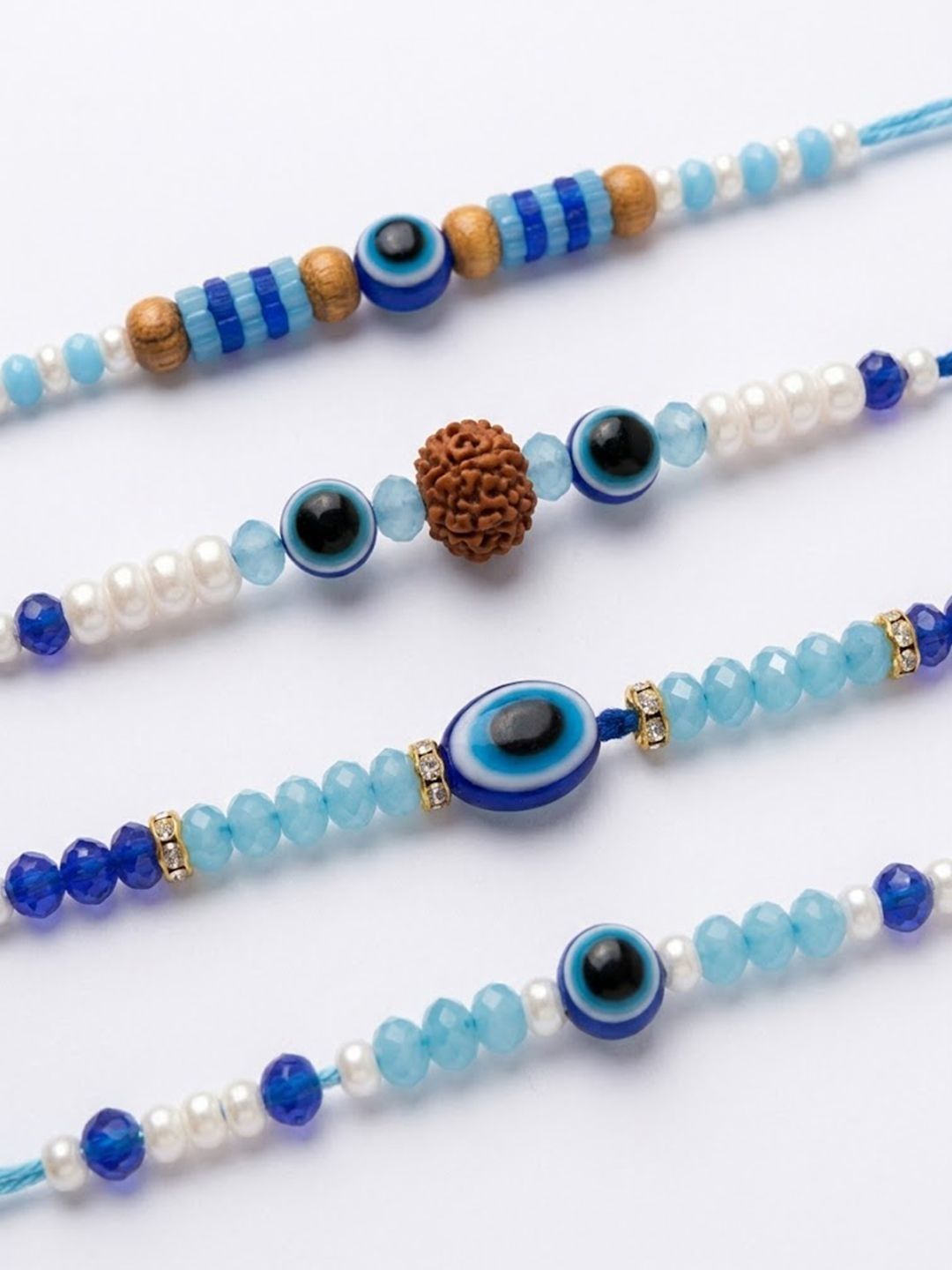 Anouk Set Of 4 Blue Evil Eye Thread Rakhi With Roli Chawal Chandan Mishri