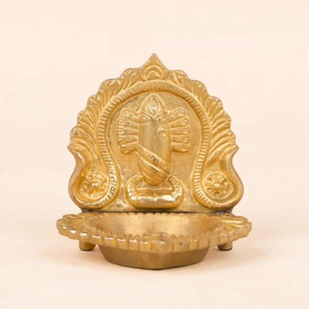 Brass Linga Bhairavi idol lamp from Isha Life, depicting a traditional Hindu deity with intricate details and a lit oil wick.