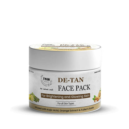 The Natural Wash De-Tan Face Pack for glowing skin, displayed in a bowl with herbal ingredients and a wooden spatula.