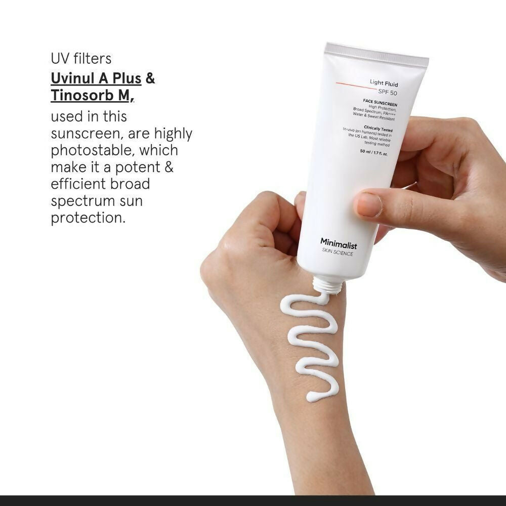 Minimalist Light Fluid Face Sunscreen with SPF 50 PA++++, lightweight and water-resistant, applied on a person's face.