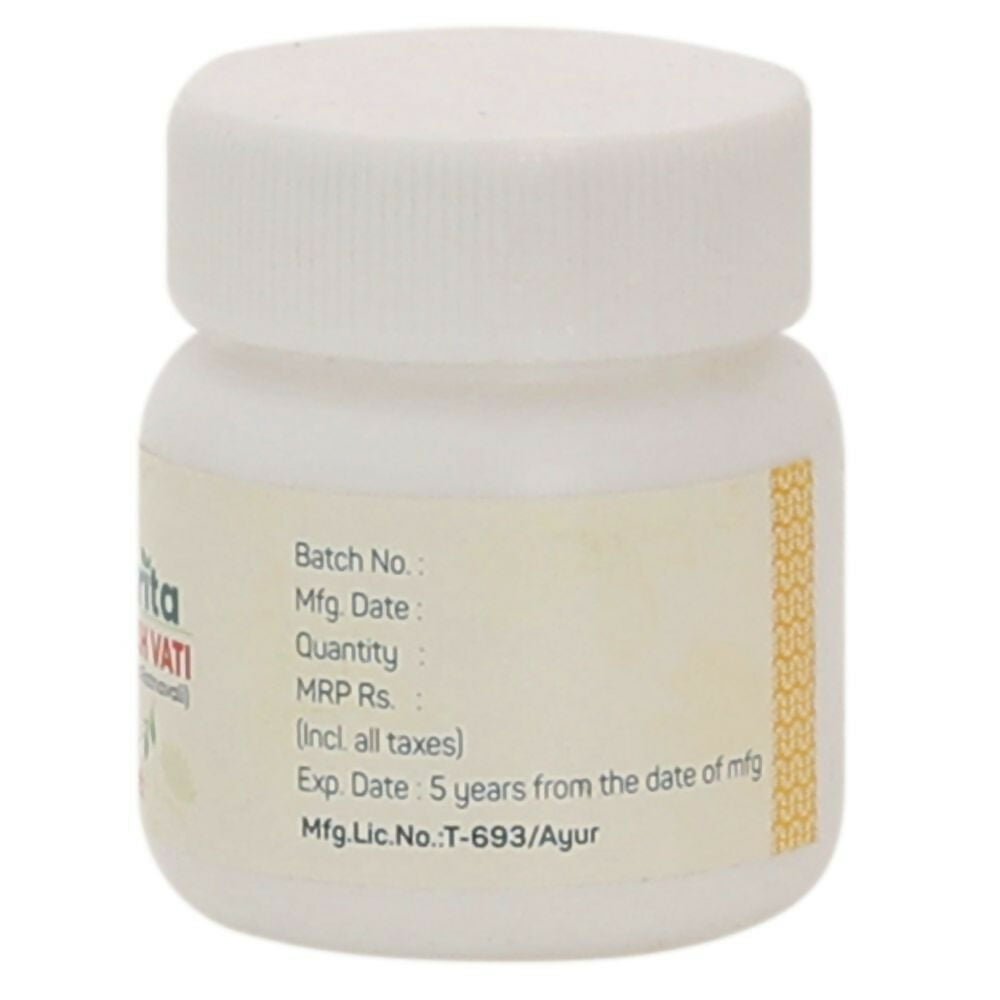 Amrita Kamdudha Ras Ayurvedic tablets in a glass bottle, showing round herbal tablets with traditional packaging.