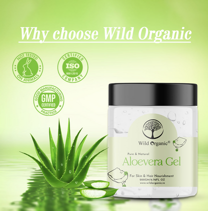 Wild Organic pure aloe vera gel for face, natural and organic, in a clear jar with fresh aloe vera leaves in the background.