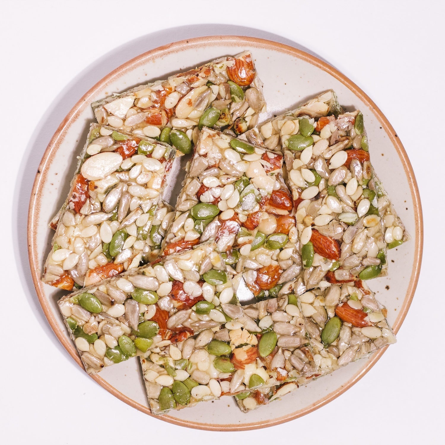 Shree Mithai Sugarfree 4 In 1 Chikki, North Indian sweets made with jaggery and nuts, displayed on a plate.