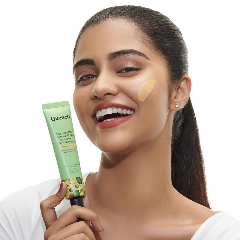 Quench Vitamin E Tinted SPF 50 Sunscreen with mineral and chemical actives, light medium shade, showing the tube and product label.
