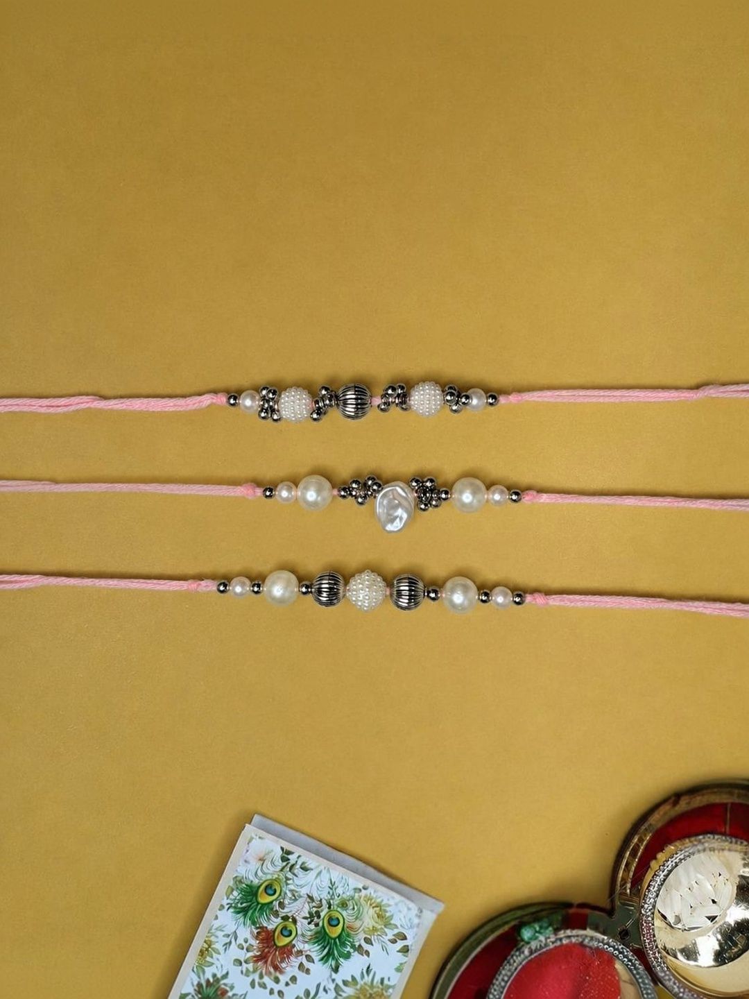 Anouk Set Of 3 White Pearls Thread Rakhi With Roli Chawal Chandan Mishri