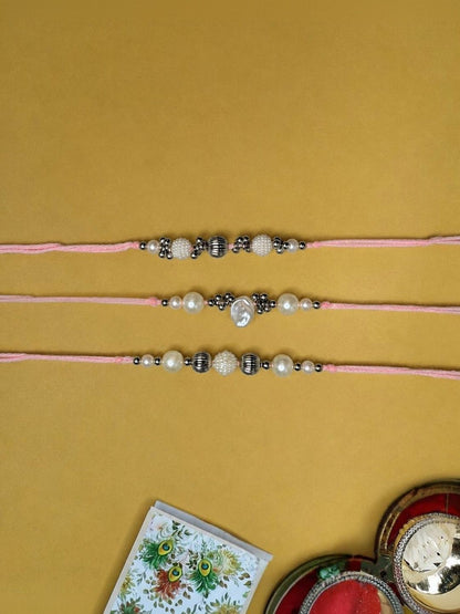 Anouk Set Of 3 White Pearls Thread Rakhi With Roli Chawal Chandan Mishri