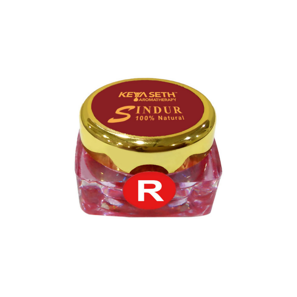 Red Sindoor powder in a container from Keya Seth Aromatherapy, natural makeup product for traditional Indian adornment.