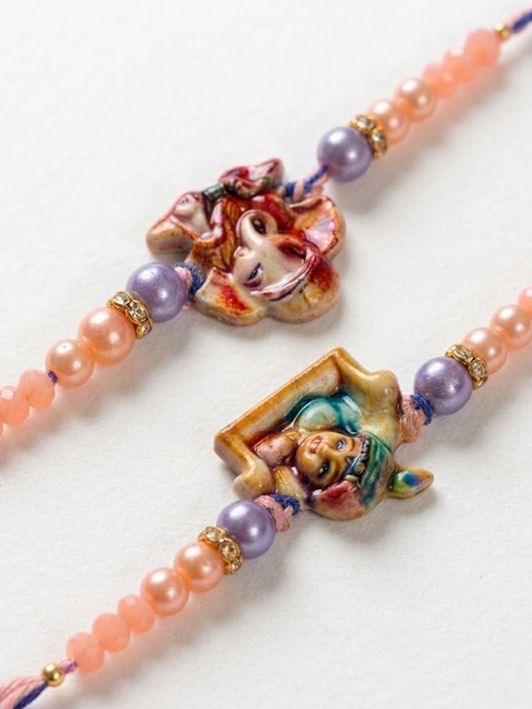 Anouk Set Of 2 Krishna Ji & Ganesh Ji Beaded Religious Thread Rakhi With Roli Chawal